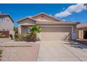 Charming home with two car garage, desert landscaping, and well maintained lawn at 8010 W Adam Ave, Peoria, AZ 85382