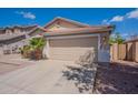 Attached two-car garage with a paved driveway and well-maintained exterior at 8010 W Adam Ave, Peoria, AZ 85382