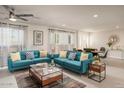 Bright and airy living room featuring stylish blue sofas, modern decor, and ample natural light at 8220 E Crestwood Way, Scottsdale, AZ 85250
