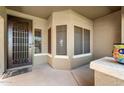 Inviting front porch featuring a secure screen door and a cozy seating area with ample natural light at 1115 E Locust Dr, Chandler, AZ 85286