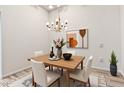 Dining room with chandelier, dining table and chairs, decorative rug, and a modern design at 13821 N Thunderbird Blvd, Sun City, AZ 85351