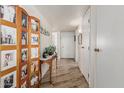 Bright hallway with white walls, wood-look tile flooring, and a decorative wood screen at 13821 N Thunderbird Blvd, Sun City, AZ 85351