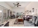 Inviting living room featuring a ceiling fan, light wood floors, and sliding glass door to the outside at 13821 N Thunderbird Blvd, Sun City, AZ 85351