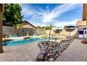 Backyard oasis featuring a stunning pool with rock accents, perfect for relaxing at 14282 W Indianola Ave, Goodyear, AZ 85395