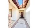 Inviting entryway with a brown front door and desert landscaping along the walkway at 1516 E Azalea Dr, Gilbert, AZ 85298