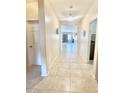 Inviting hallway featuring neutral tile floors and views into the living space at 1516 E Azalea Dr, Gilbert, AZ 85298