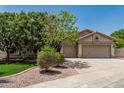 Charming single-story home featuring a well-manicured lawn, mature trees, and a spacious three-car garage at 1754 W San Tan St, Chandler, AZ 85224