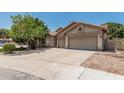 Well-maintained home with a three-car garage, tile roof, desert landscaping, and a spacious driveway at 1754 W San Tan St, Chandler, AZ 85224