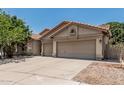 Well-maintained home with a three-car garage, tile roof, desert landscaping, and a spacious driveway at 1754 W San Tan St, Chandler, AZ 85224