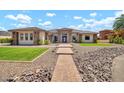 Attractive house featuring stonework accents and a well-maintained lawn at 18225 W San Juan Ct, Litchfield Park, AZ 85340