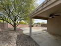 View of backyard patio with desert landscaping and a ceiling fan for outdoor comfort at 2042 N Parish N Ln, Casa Grande, AZ 85122