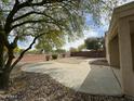 Spacious backyard featuring a concrete patio, desert landscaping, and a privacy fence at 2042 N Parish N Ln, Casa Grande, AZ 85122