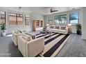 Bright living room featuring neutral walls, ample windows, and stylish black and white accents at 21334 E Lords Ct, Queen Creek, AZ 85142