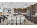 Modern kitchen with granite countertops, stainless steel appliances, and a large center island at 21716 S 225Th Way, Queen Creek, AZ 85142