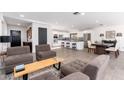 Open-concept living area with modern furnishings, leading to a spacious kitchen and dining space at 2712 E Mountain View Rd, Phoenix, AZ 85028