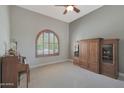 Bright living room with arched window, custom shutters, and built-in cabinet at 2784 E Honeysuckle Pl, Chandler, AZ 85286