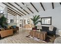 Spacious living room flows to dining area with vaulted ceilings, wood beams, and stylish furniture, perfect for gatherings at 2839 N 61St St, Scottsdale, AZ 85257