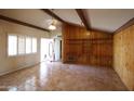 Living room featuring tile floors, wood-beam accents and shuttered windows at 36655 N 25Th St, Cave Creek, AZ 85331