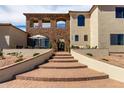 Grand entryway with brick steps leading to an outdoor seating area under a stone arch at 3723 S Pottery Rd, Gold Canyon, AZ 85118