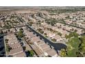 Planned community aerial view with homes neatly arranged along tree-lined streets at 4626 N 111Th Ln, Phoenix, AZ 85037