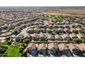 Aerial view of a community featuring lush green spaces and desert views in the background at 4626 N 111Th Ln, Phoenix, AZ 85037