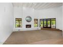 Bright living room with fireplace, large windows, and access to the outdoor patio area at 5838 E Berneil Ln, Paradise Valley, AZ 85253