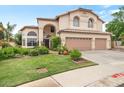 Beautiful two-story home with a two-car garage, mature trees, lush lawn, and desert landscaping at 5839 W Ironwood Dr, Glendale, AZ 85302
