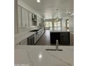 Bright, spacious kitchen with quartz countertops, stainless steel appliances, and an island with a wine cooler at 6337 W Deer Valley Rd, Glendale, AZ 85308