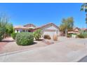 Single-story home featuring a two-car garage and desert landscaping at 67 N Montoro Ln, Casa Grande, AZ 85194
