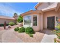 A cozy front entrance with a brick walkway and a bay window at 67 N Montoro Ln, Casa Grande, AZ 85194