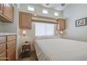 Cozy bedroom with a comfortable bed, soft lighting, and ample storage cabinets at 7750 E Broadway Rd # 535, Mesa, AZ 85208