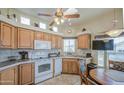 Well-lit kitchen with wooden cabinets, appliances, and a ceiling fan that enhances the atmosphere at 7750 E Broadway Rd # 535, Mesa, AZ 85208