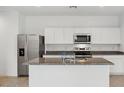 Bright kitchen features stainless steel appliances, granite countertops, and a center island at 8440 W Clemente Way, Florence, AZ 85132