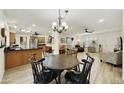 Open-concept dining area showcasing wood floors and seamless flow to kitchen and living spaces at 1056 S 81St St, Mesa, AZ 85208