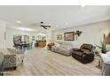 Bright and airy living room featuring neutral tones, a ceiling fan, and wood-look flooring at 1056 S 81St St, Mesa, AZ 85208