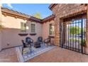 Inviting courtyard with stylish chairs, a fire pit, and a gated entrance at 15716 W Sheridan St, Goodyear, AZ 85395