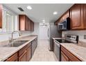 Traditional galley kitchen features stainless steel appliances and tile flooring at 15801 N 29Th St # 16, Phoenix, AZ 85032