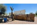 A wooden plank fence lines the backyard, along with a small palm tree and some trash receptacles at 1731 E Moreland St, Phoenix, AZ 85006