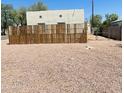 A long flat backyard that is primarily xeriscaped with a DIY plank fence in the foreground at 1731 E Moreland St, Phoenix, AZ 85006