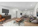 Spacious living room featuring modern decor and a dining area, virtually staged at 1822 W Rose Ln, Phoenix, AZ 85015