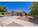 Street view of a well-maintained, one-story home with a two-car garage and desert landscaping on a sunny day at 21277 E Cherrywood Dr, Queen Creek, AZ 85142