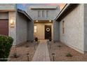 Inviting front entrance with a brick pathway, stylish door, and well-maintained desert landscaping at 22842 E Via Las Brisas --, Queen Creek, AZ 85142