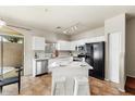 Modern kitchen with an island, bar stool seating, stainless steel appliances and granite countertops at 2402 E 5Th St # 1741, Tempe, AZ 85288