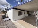 Exterior view of a mobile home featuring an attached carport, windows, and siding at 303 S Recker Rd # 50, Mesa, AZ 85206