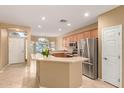 Open-concept kitchen featuring stainless steel appliances and a breakfast bar at 3239 S Tatum Ln, Gilbert, AZ 85297