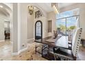 Light-filled dining room showcasing tile floors, iron transom, modern lighting, and neutral tones at 34096 N 87Th Way, Scottsdale, AZ 85266