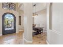 Inviting dining room features tile floors, a decorative wrought iron transom, and modern lighting at 34096 N 87Th Way, Scottsdale, AZ 85266