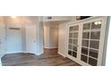 Inviting entryway with wood floors and french doors that lead to a private office space at 3434 E Baseline Rd # 168, Phoenix, AZ 85042