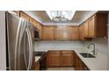 Updated kitchen with stainless steel appliances, wooden cabinets, and white countertops at 3434 E Baseline Rd # 168, Phoenix, AZ 85042