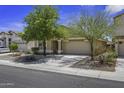 Charming single-story home with a well-manicured, low maintenance front yard and an attached two car garage at 40749 W Thornberry Ln, Maricopa, AZ 85138